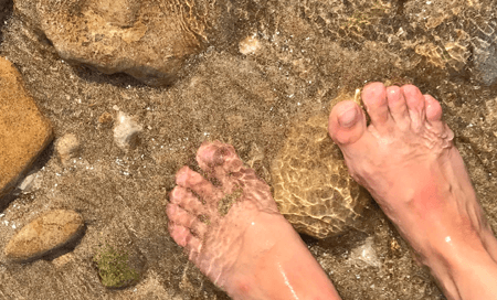 Feet in the sea on beach